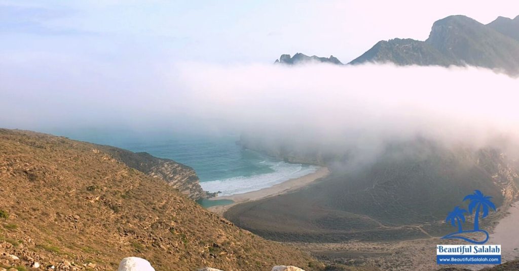 Clouds touching the mountains of Masood Hidden Beach Salalah